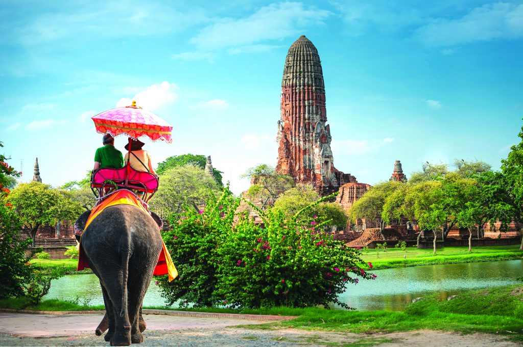 Tourists on an elephant ride tour of the ancient city Ayutaya ,t