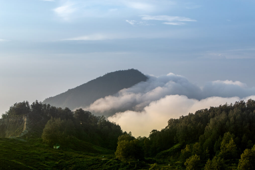 View of the Lewotobi Volcano Indonesia, with forest and clouds rising. Flores Island, Indonesia_adobe