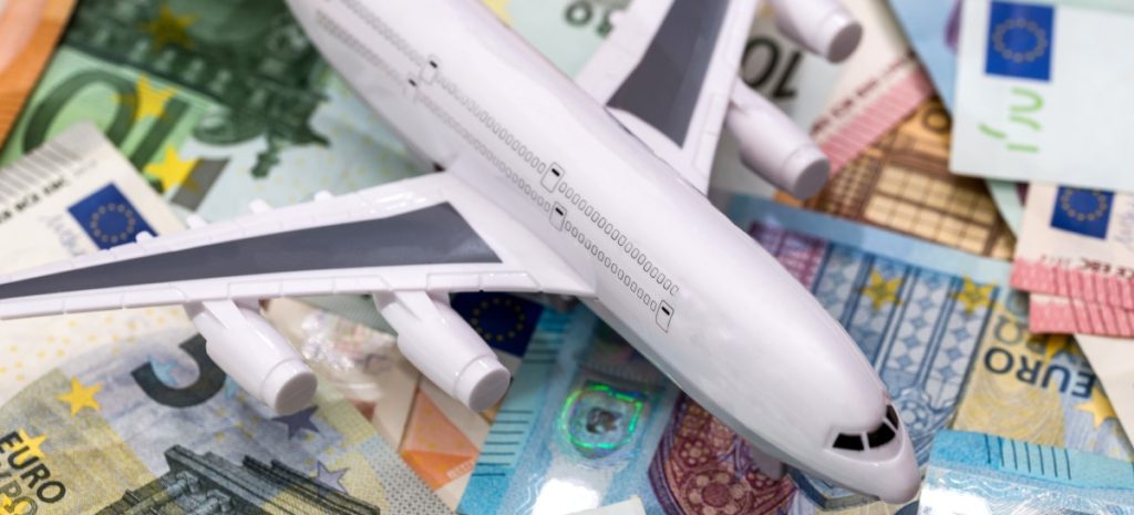euro money on a plane to travel_adobe